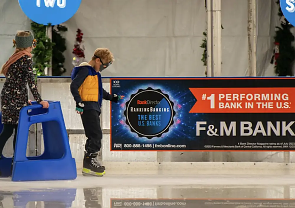 A sponsor dasher board on the rink boards at a Special Ice rink