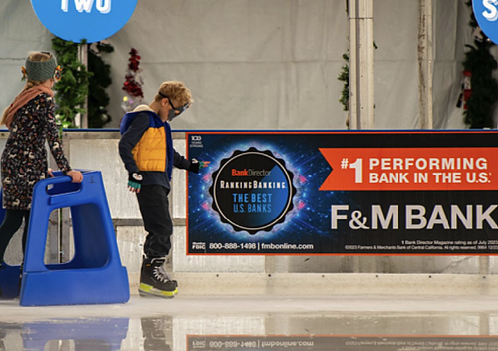 A sponsor dasher board on the rink boards at a Special Ice rink
