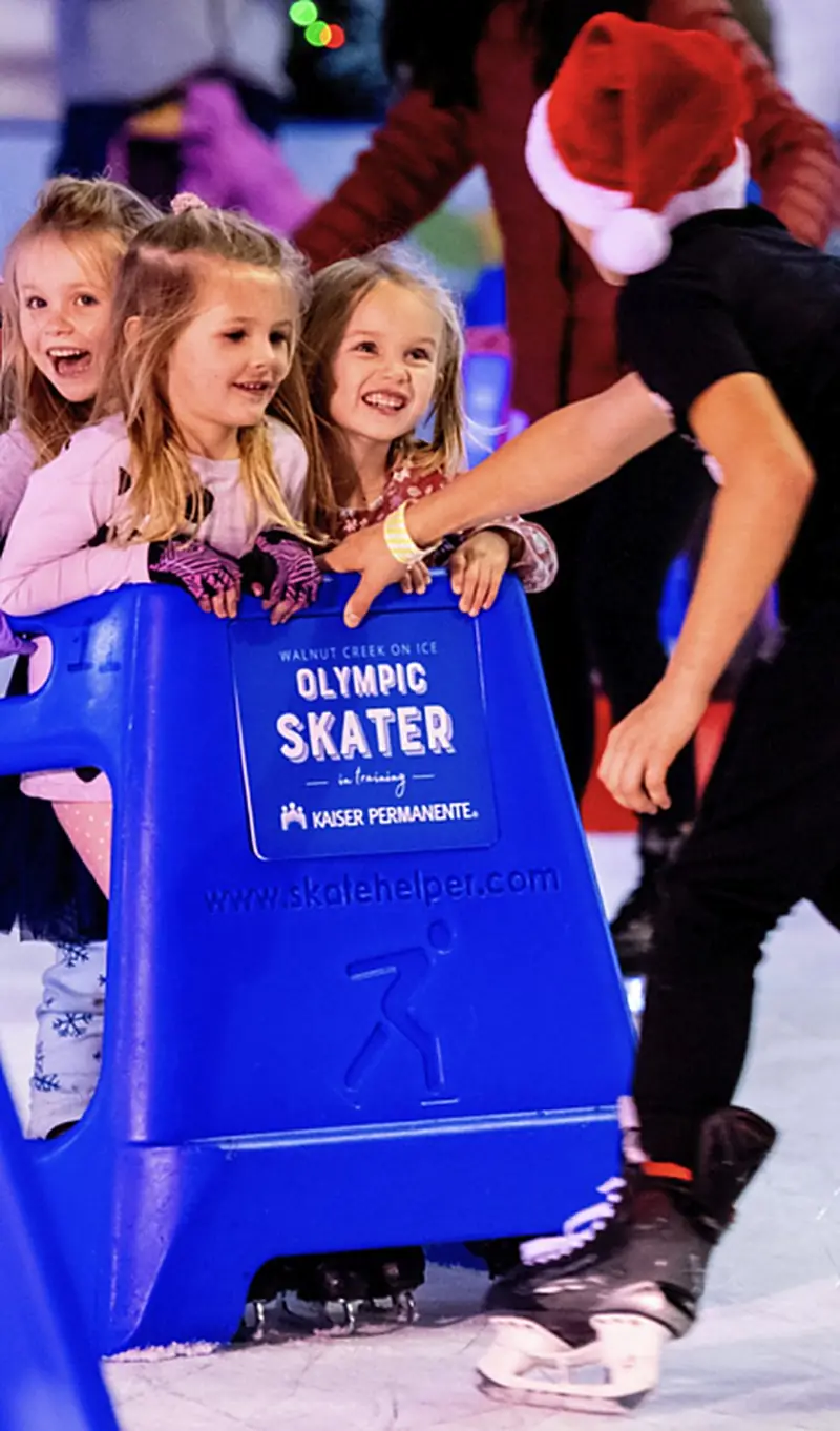 Young skaters using skate helpers on the ice at a Special Ice rink